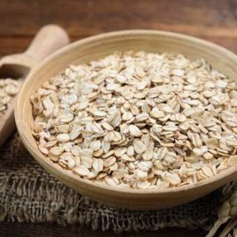 Rolled oats in a wooden bowl. Healthy whole grain oats